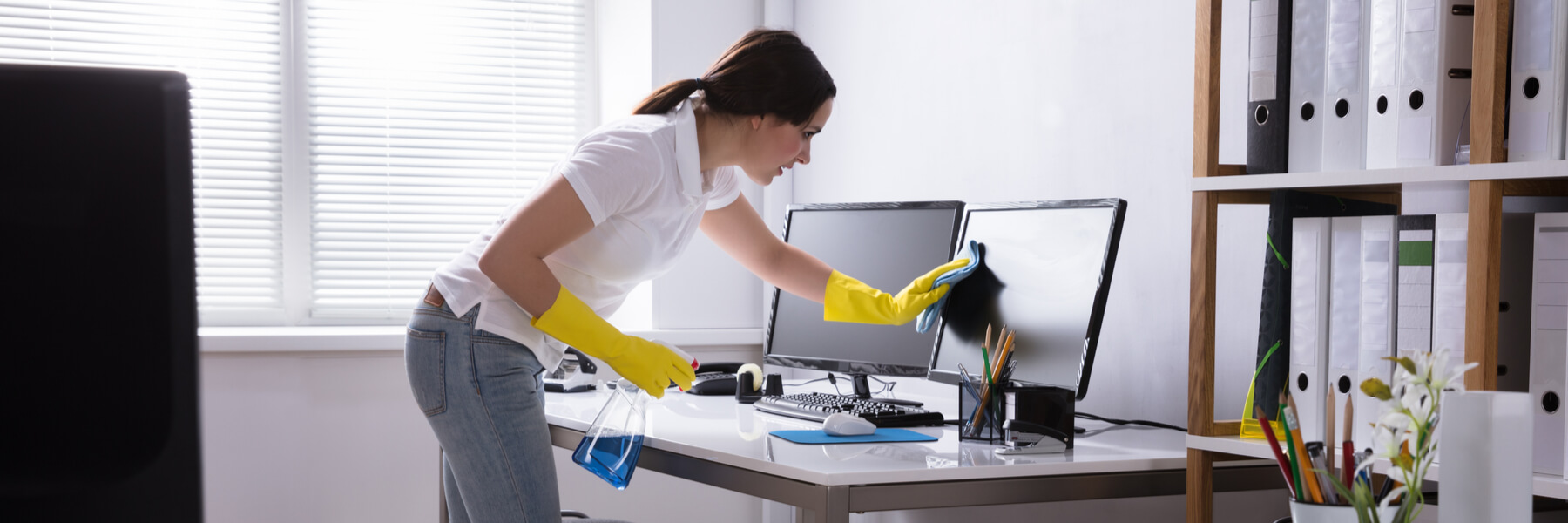 A woman cleaning her office