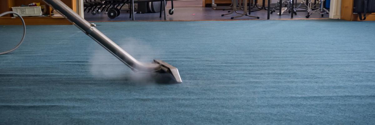 Commercial carpet cleaner steaming office carpet